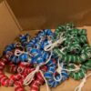A box of soda cans with strings attached to them.