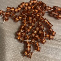 A bunch of brown beads are laying on the floor