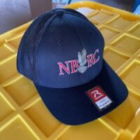A black hat with the letters nbrc on it|A baseball cap with the words nrrc on it.|A hat sitting on top of yellow plastic trays.