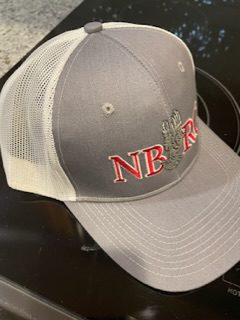 A grey and white hat with the letters nb r on it.|A gray and white hat with the words nbrc on it.