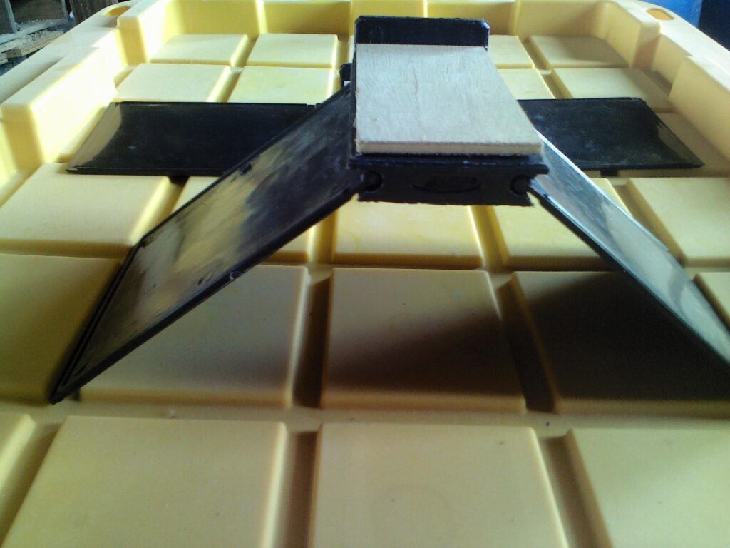 A tablet sitting on top of a table.|A black belt is laying on the floor