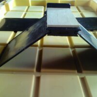 A tablet sitting on top of a table.|A black belt is laying on the floor