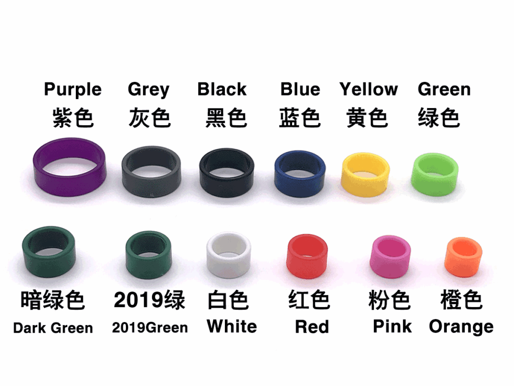 A group of different colors and sizes of rings.|A white sheet with many different colors of rings