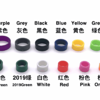 A group of different colors and sizes of rings.|A white sheet with many different colors of rings