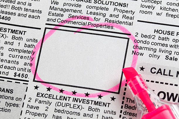 A pink marker is stuck in the side of a newspaper.|