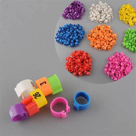 |||A box of different colored beads sitting on top of a table.